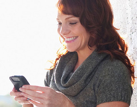 Laughing woman with a smartphone